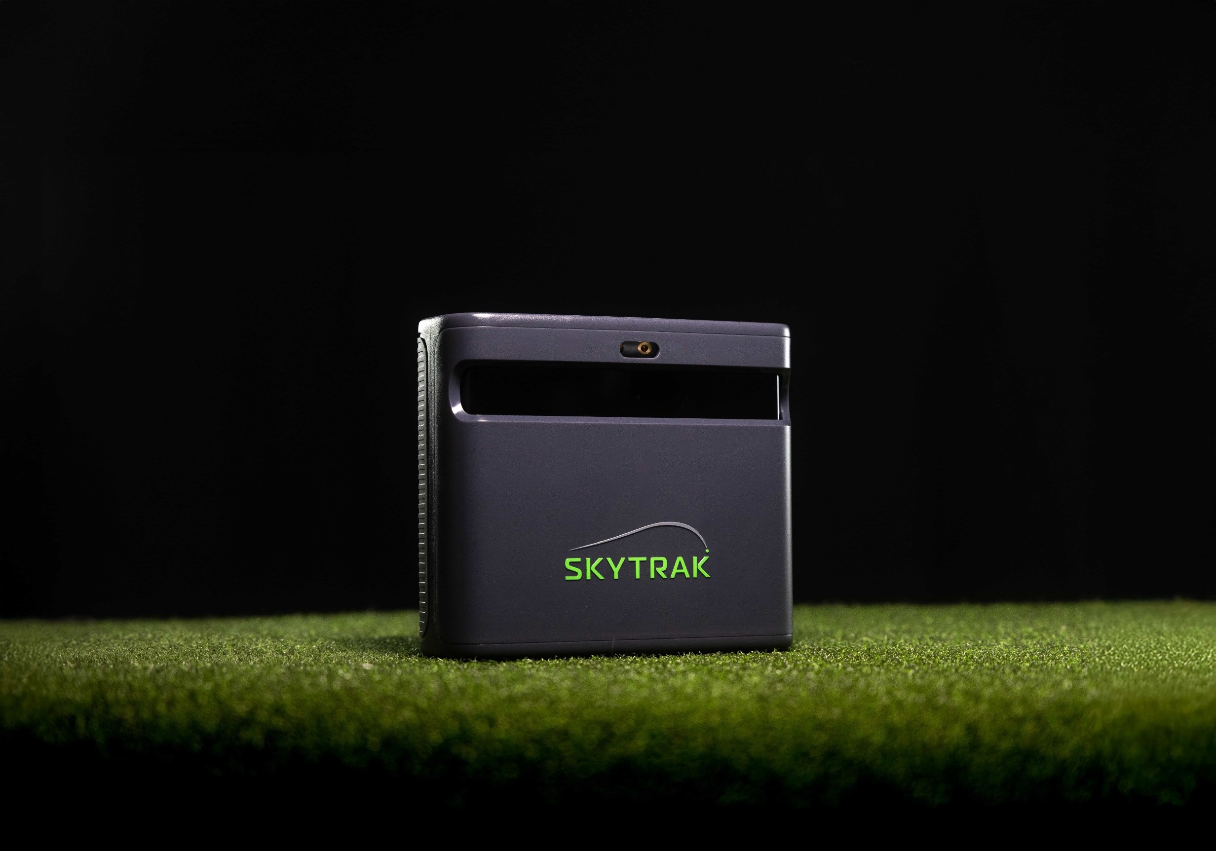 SkyTrak MAX shown in a golf simulator