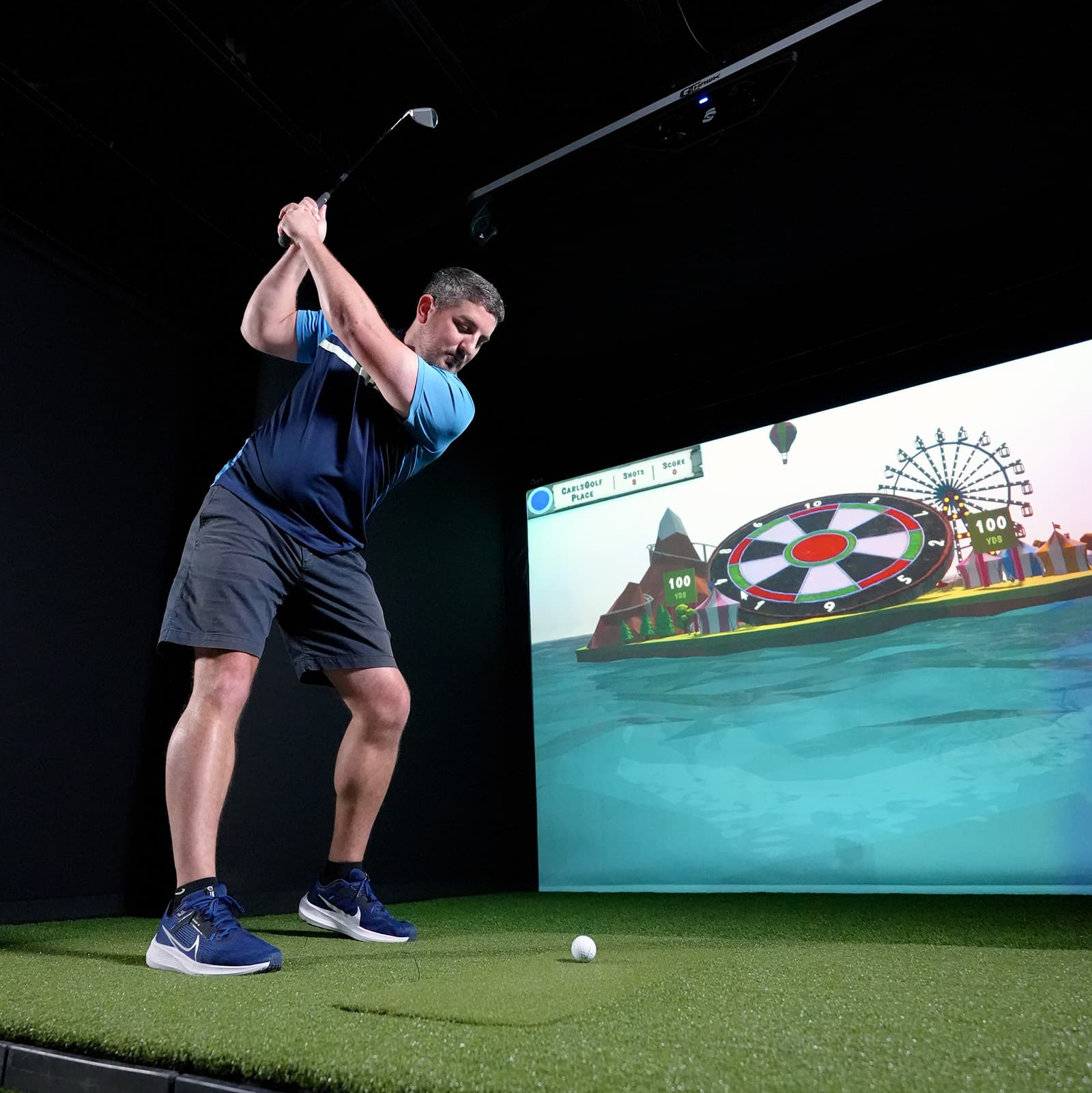 GCHawk in golf simulator with golfer