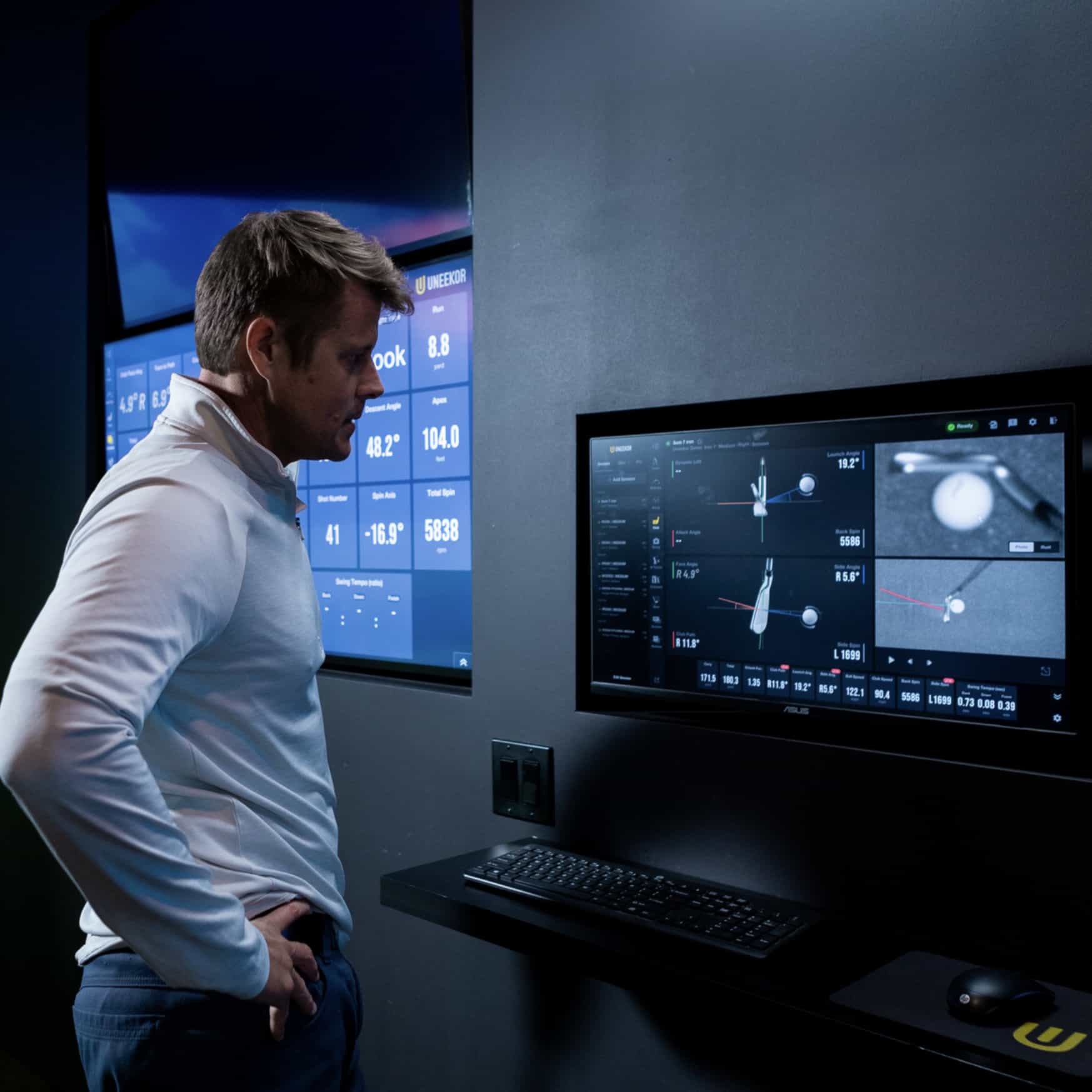 Golfer looking at the data provided by the Uneekor Eye XR