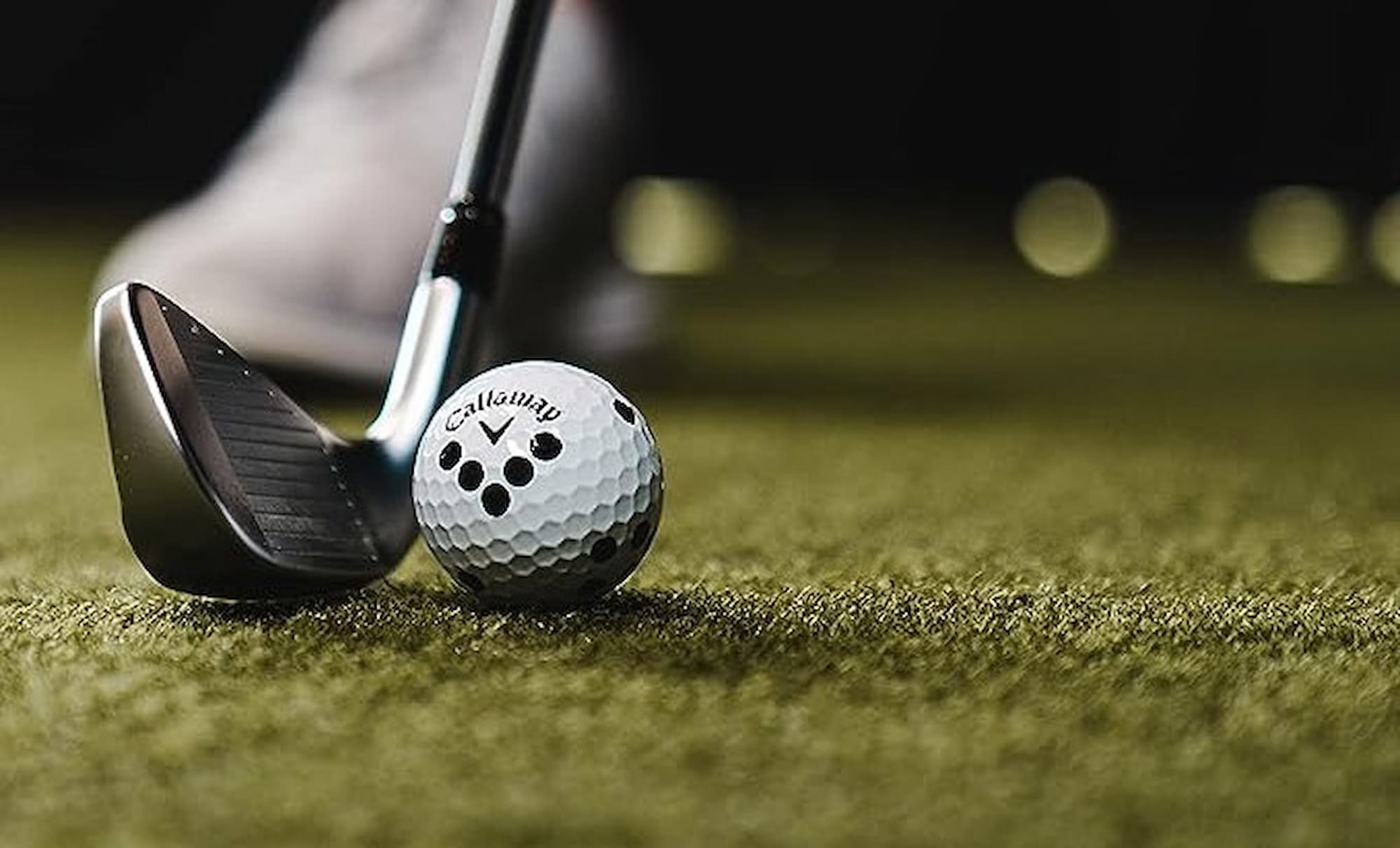 Marked golf ball with club behind
